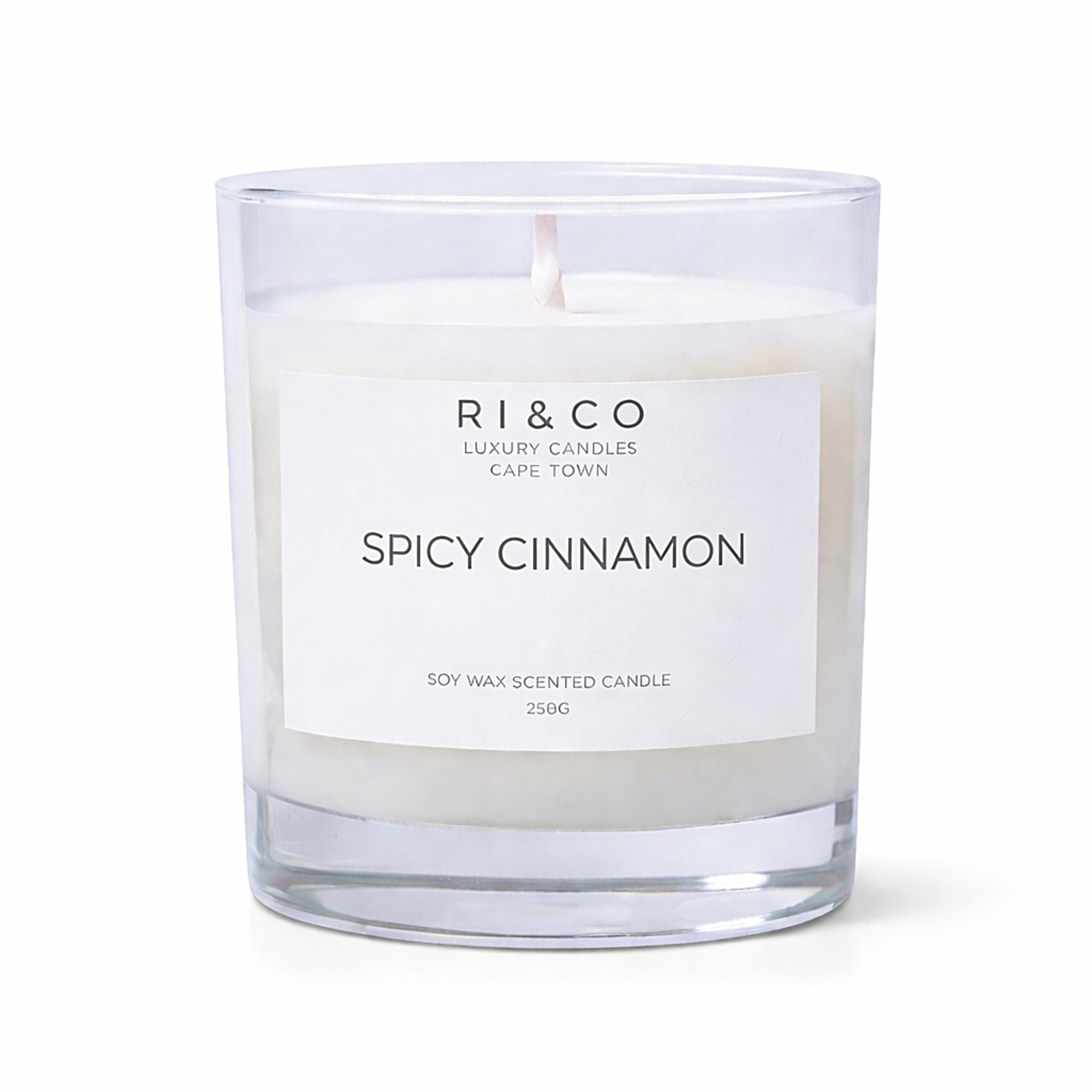 RI & CO Spicy Cinnamon luxury soy wax candle in clear glass jar on white background
