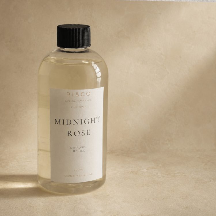 Luxury Midnight Rose reed diffuser refill by RI&CO with elegant neutral luxury packaging and warm editorial styling.